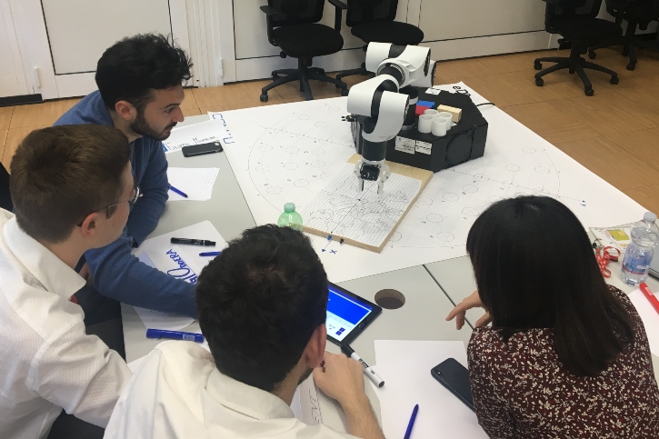 students working in Comau with real robots