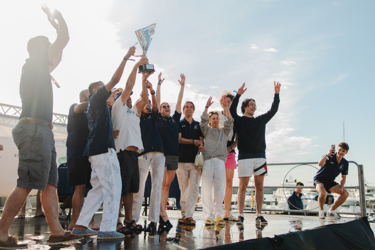 Victory on the water, celebration on land — a winning crew shares a moment of triumph.