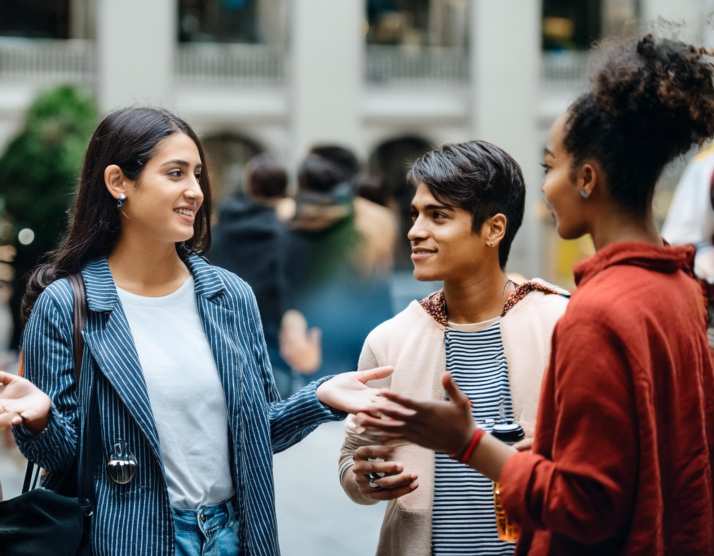 Three ESCP students coming out of a campus