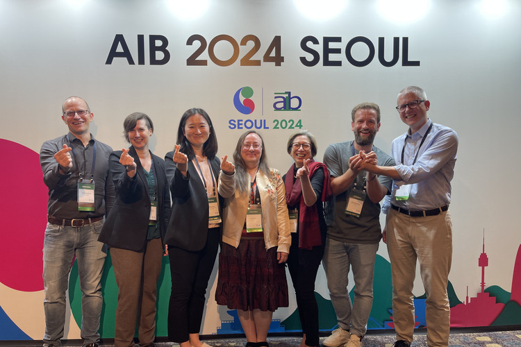 Group photo of Marc Oberhauser and fellow AIB Sustainability SIG members standing together at the AIB 2024 conference in Seoul.