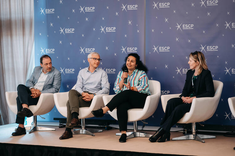 Professor Wafa Ben Khaled speaking into a microphone during a panel discussion at ESCP Full Faculty Reunion 2025, seated between Professor Kamran Razmdoost, Professor Louis-David Benyayer and Professor Alberta Di Giuli against an ESCP-branded backdrop.