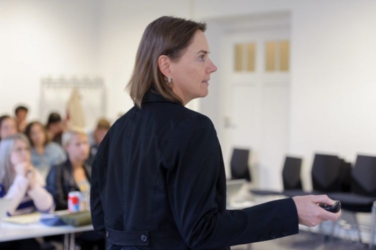 Speaker of a conference pointing on her slide