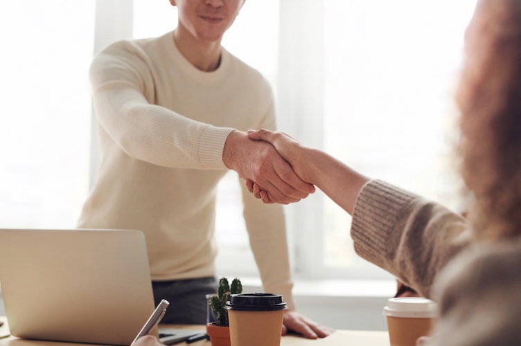 Interview applicant shaking hands with employer