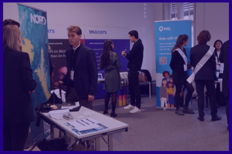 Image of students speaking with company representatives