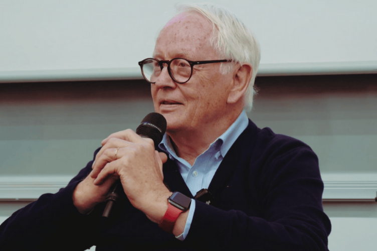 Werner Bahlsen sitting with a microphone, speaking at ESCP Business School Berlin