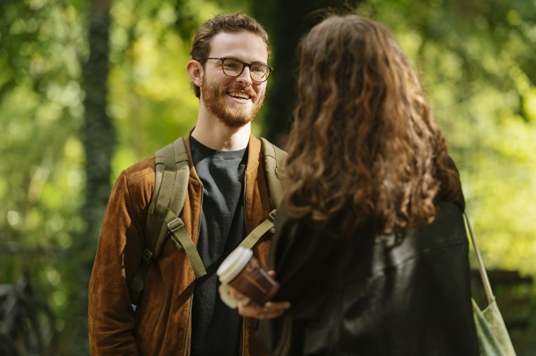 Student on the Berlin campus smiling and talking to a classmate