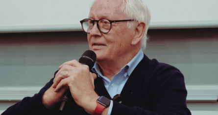 Werner Bahlsen sitting with a microphone, speaking at ESCP Business School Berlin