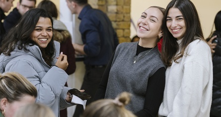 3 smiling female students