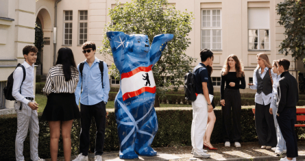 Students outside the Berlin Campus with a Berlin Bear