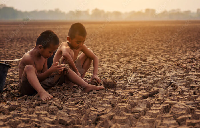 Poor boys on dry cracked land.
