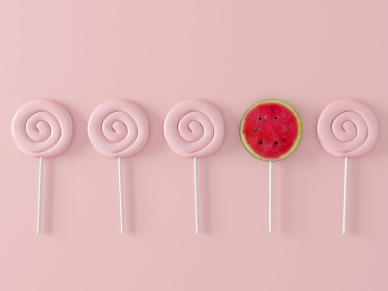 Watermelon candy on pastel pink background.