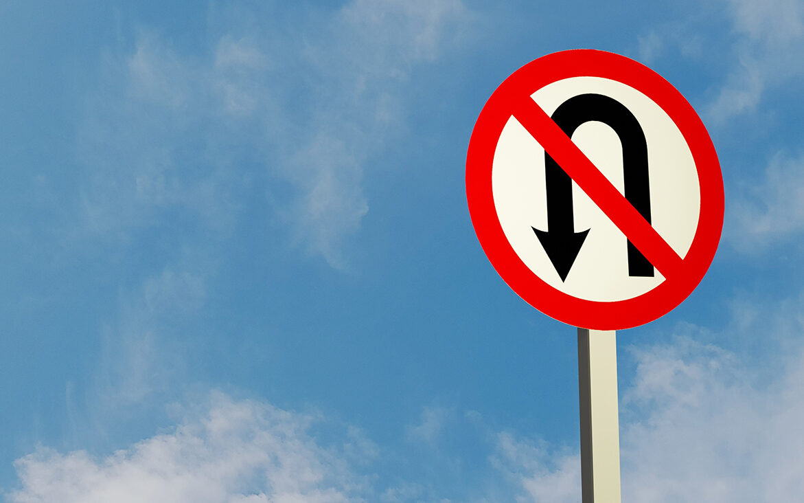 AdobeStock_Nattapat Illustration of a "Do not U-turn" traffic sign and a sky background.
