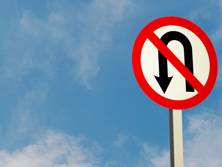 Illustration of a "Do not U-turn" traffic sign and a sky background.