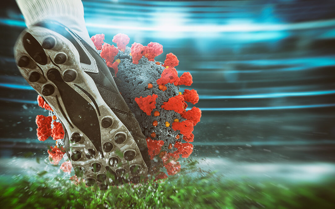 alphaspirit-AdobeStock Soccer player kicking hard the virus ball at the stadium