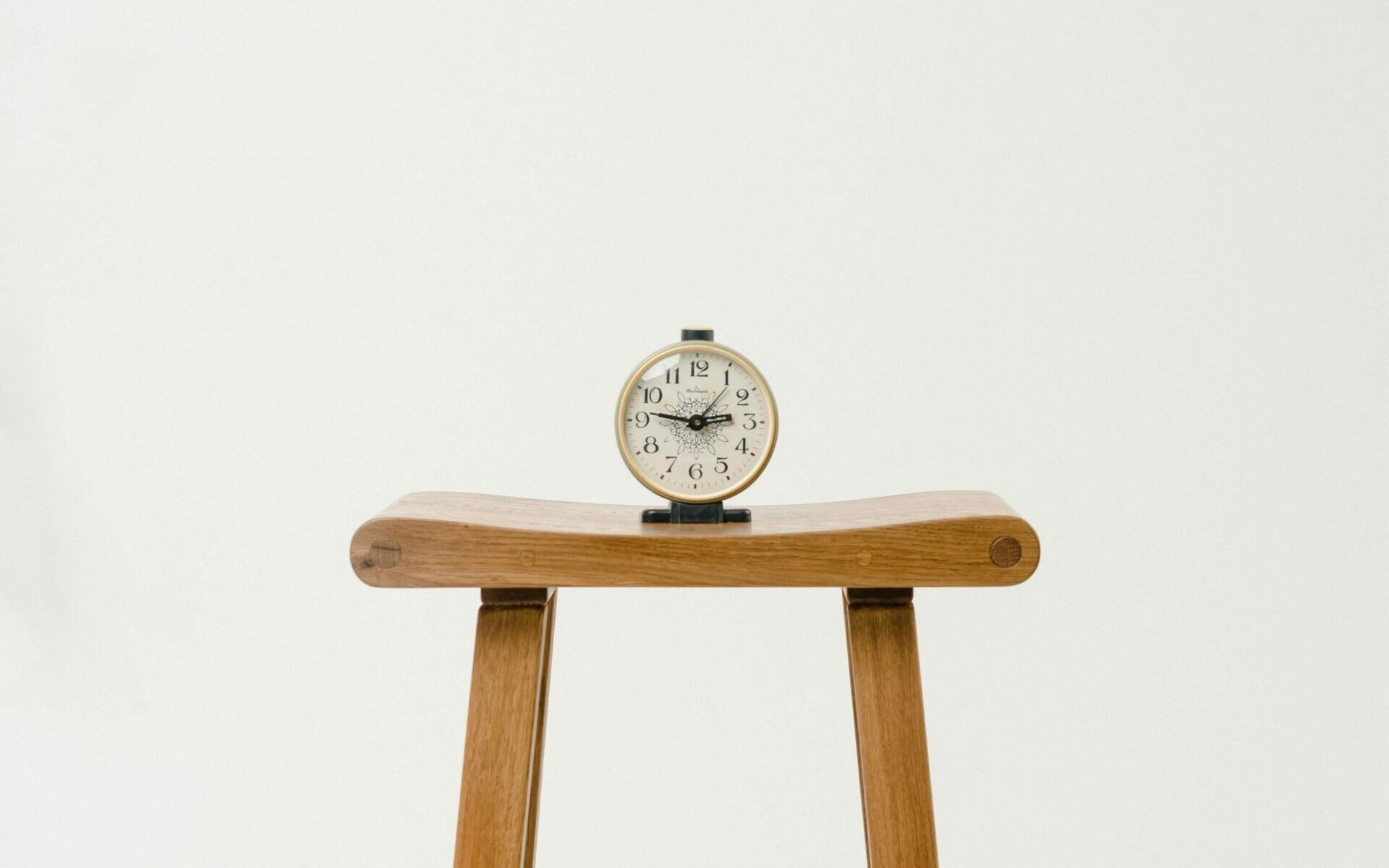 Photo-Credit-Artem-Maltsev-Unsplash An alarm clock sitting on a stool