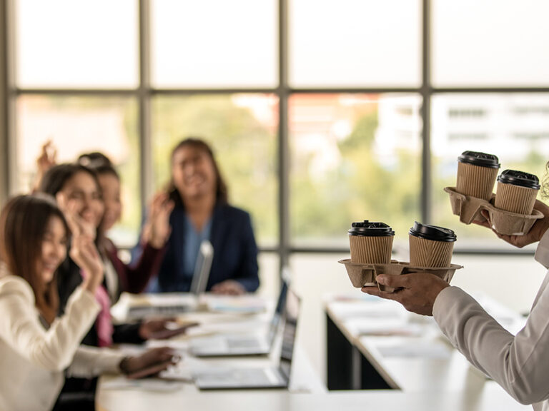 Bangkok Click Studio – AdobeStock Woman brings take-away paper cups of coffee to colleagues greeting and happy with kindness.