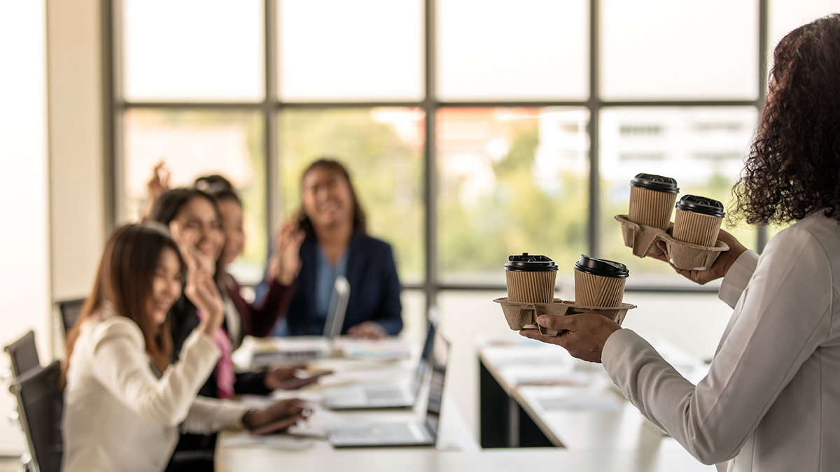 Woman brings take-away paper cups of coffee to colleagues greeting and happy with kindness.