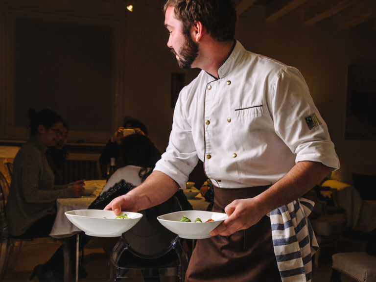 Professional chef serving dishes in a guest's home. © La Belle Assiette