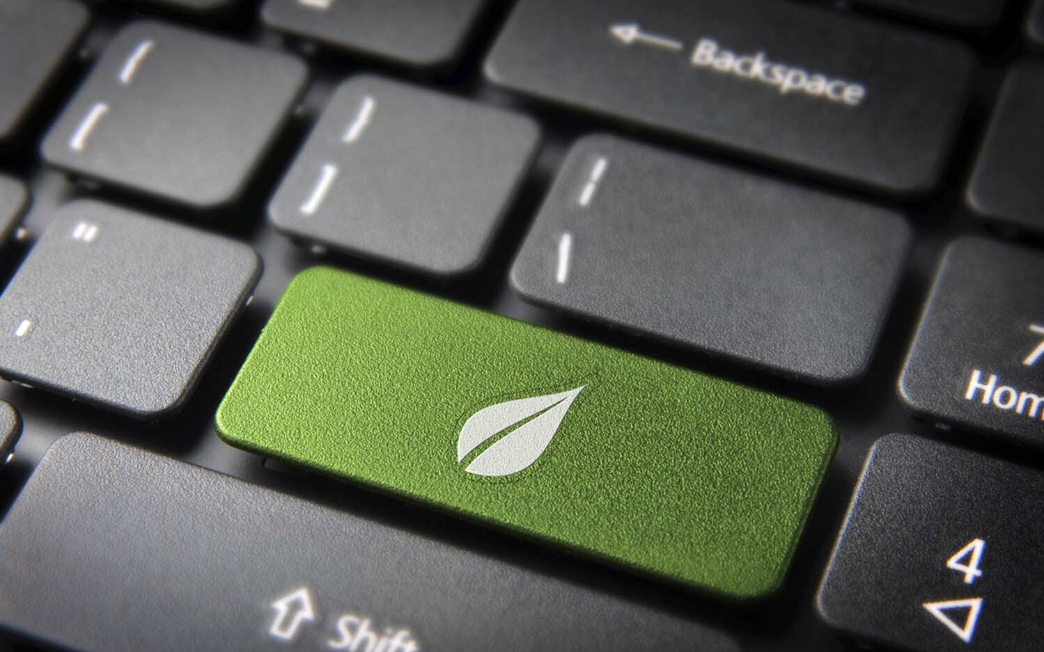 Feature photo by Cienpies/AdobeStock Green energy key with leaf icon on laptop keyboard.