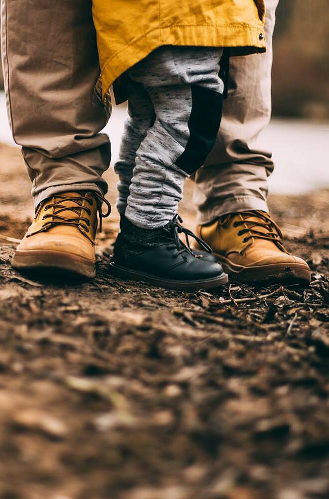 Photo of a parent and their child. Evoking the idea of family business.