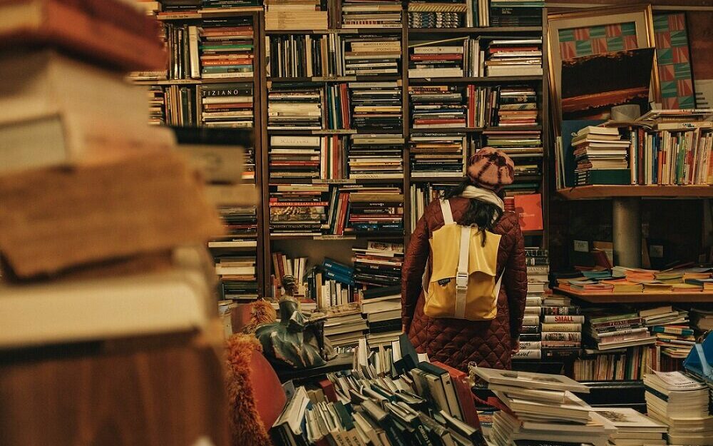 ©Darwin Vegher/Unsplash Photo of a girl looking around in a bookshop