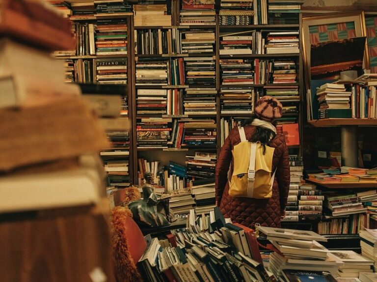 Photo of a girl looking around in a bookshop