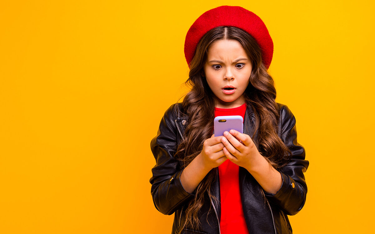 deagreez-AdobeStock Portrait of girl browsing fake news on her phone