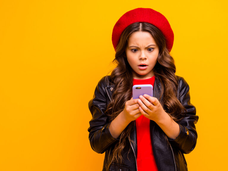 Portrait of girl browsing fake news on her phone