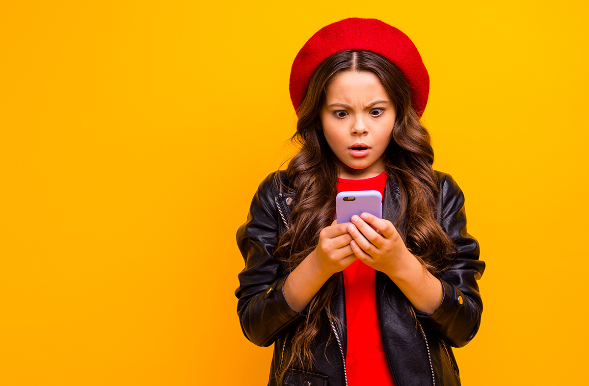 Portrait of girl browsing fake news on her phone