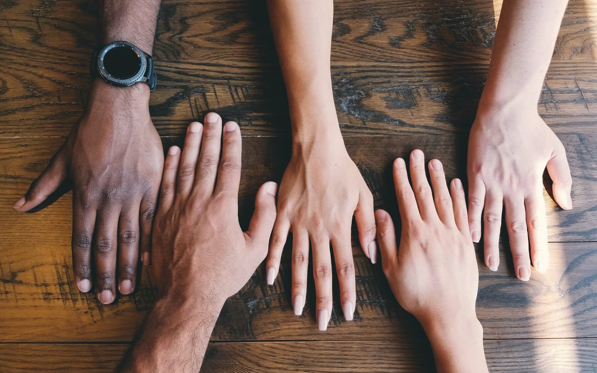Feature photo by Clay Banks/Unsplash Diversity cannot succeed without inclusion. Hands side by side on a table.