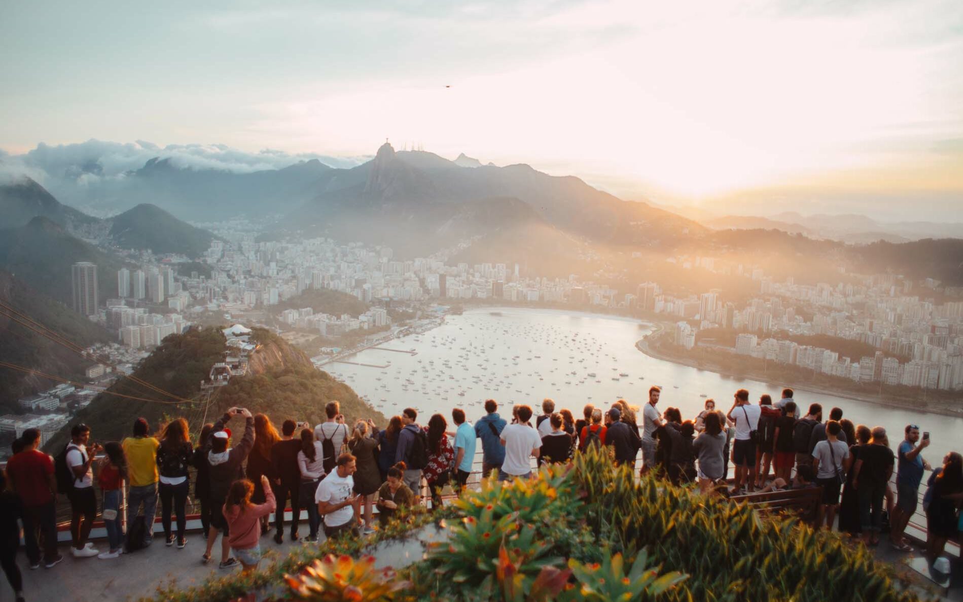 Feature photo by Elizeu Dias/Unsplash Tourists overlooking a destination.
