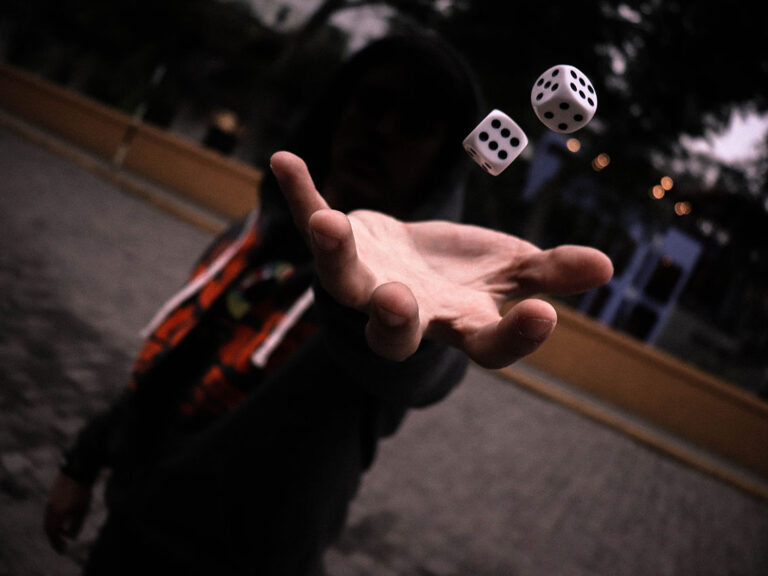 Left-handed human playing with dice, © Guillermo Velarde / Unsplash