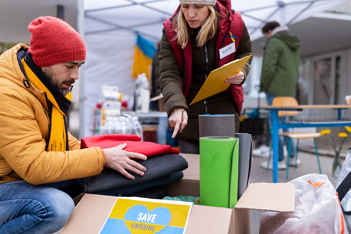 Volunteers distributing blankets and other donations to refugees on the Ukrainian border.