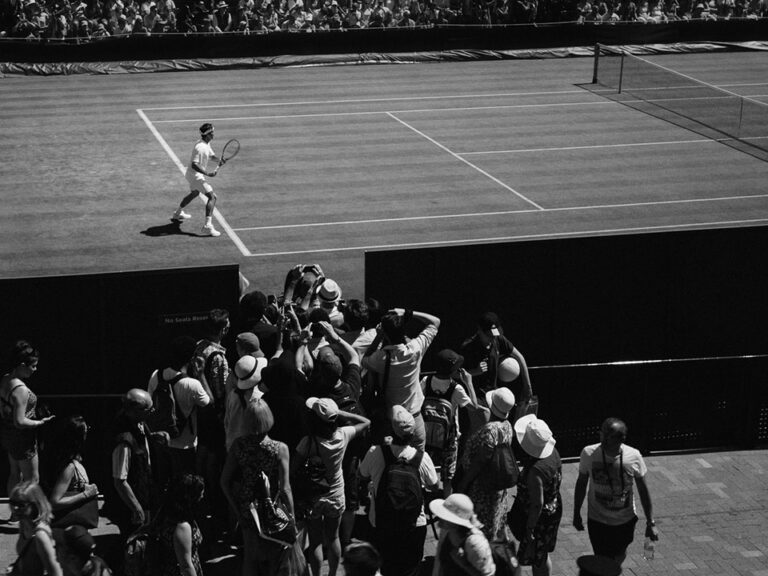 Grayscale photo of person playing tennis, © Howard Bouchevereau / Unsplash