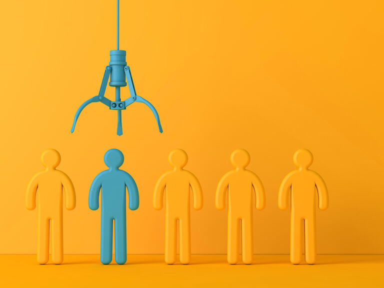 Employee recruitment concept with claw picking a new team member.