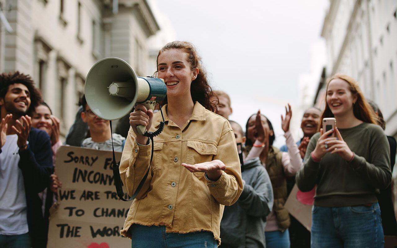 © Jacob Lund / Adobe stock Woman with a megaphone in a rally, © Jacob Lund / Adobe stock