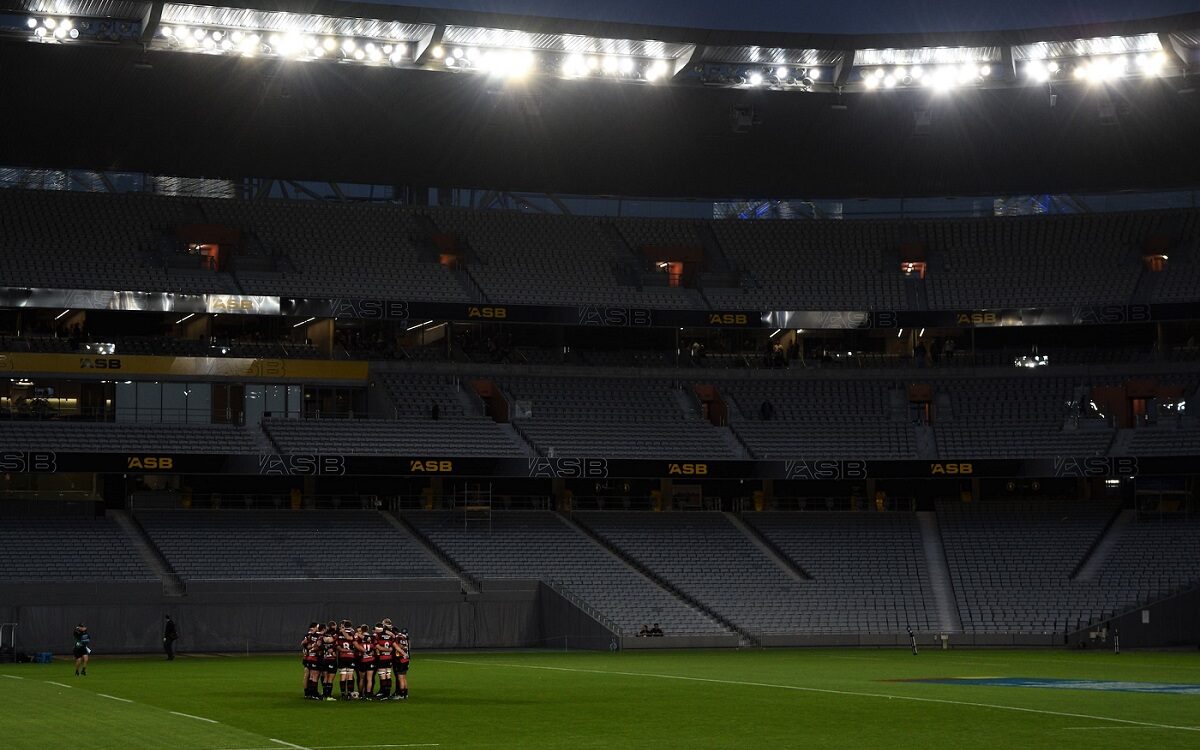 ©Jake Kokot/Unsplash Photo of a rugby team huddled up in a stadium