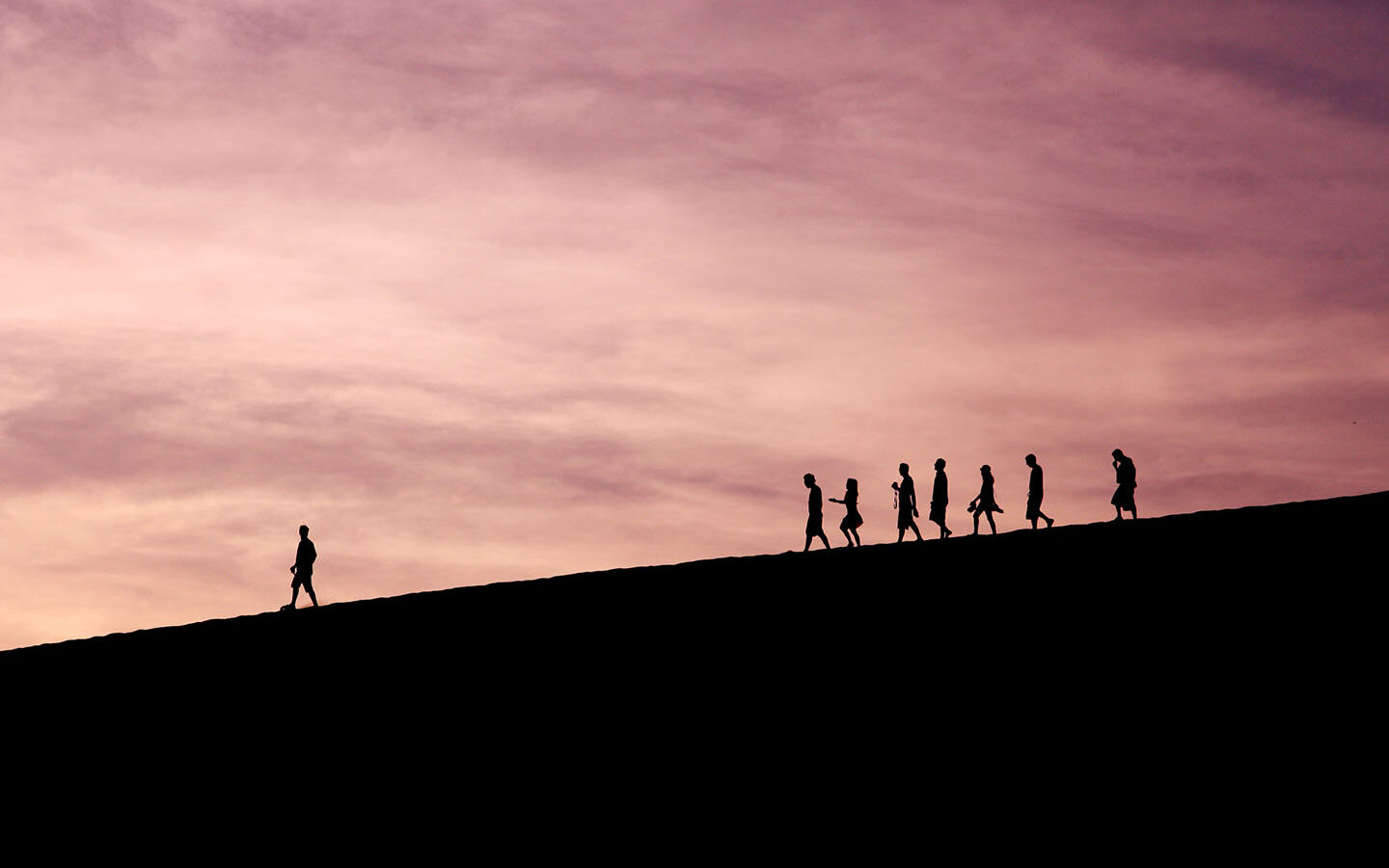 Photo Credit: Jehyun Sung/Unsplash Person standing ahead of a group, leading them forward.