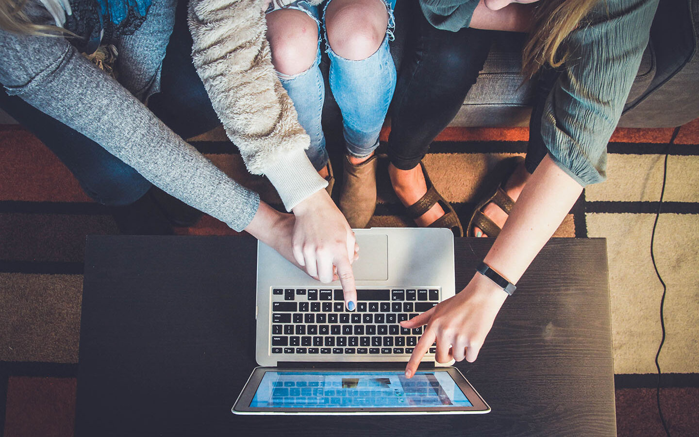 Photo Credit: John Schnobrich/Unsplash Three co-workers working together on the same screen. Feature photo by John Schnobrich on Unsplash.