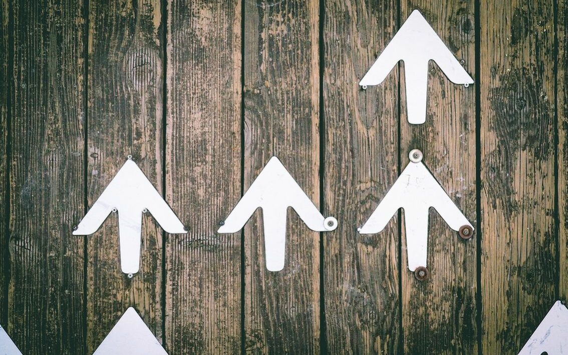 ©Jungwoo Hong/Unsplash Image of four arrows pinned to a piece of wood.