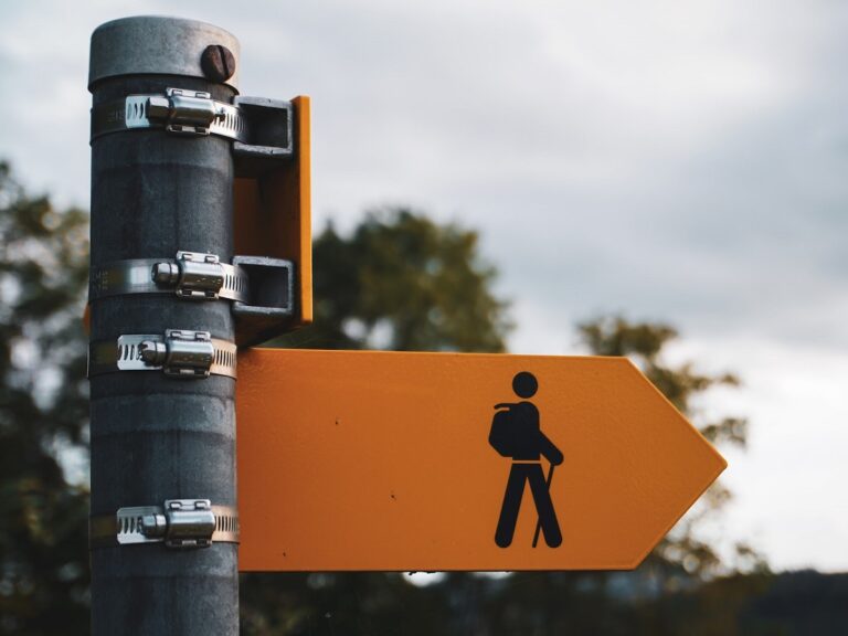 Image of an arrow point to the right with an illustration of a hiker point ti