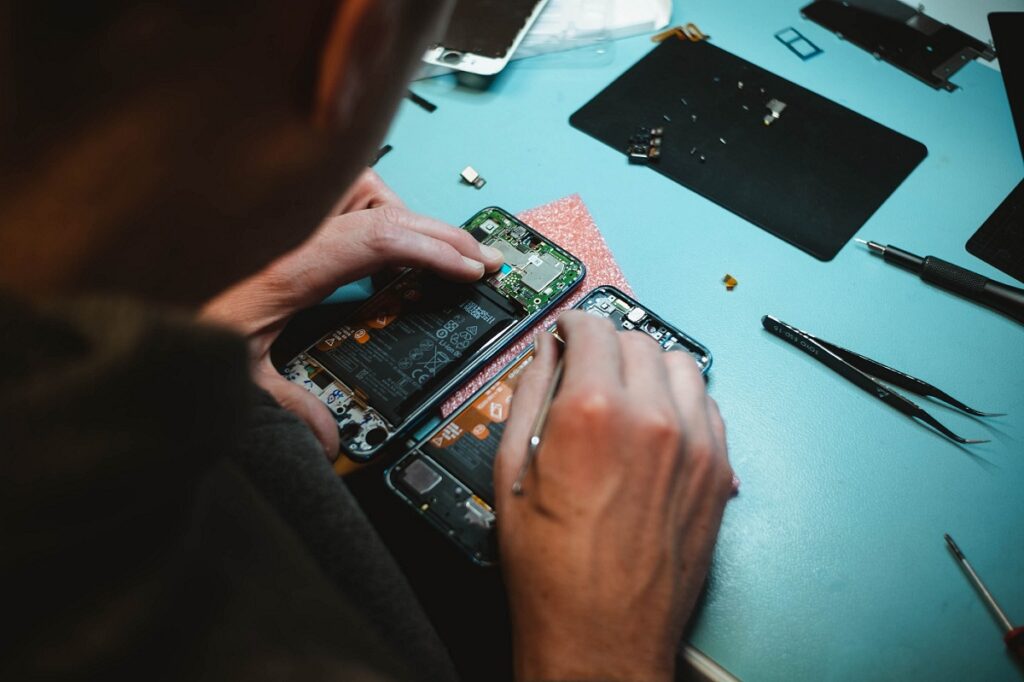 Person repairing a smartphone
