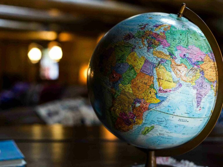 A close-up photo of a globe sitting on a table.