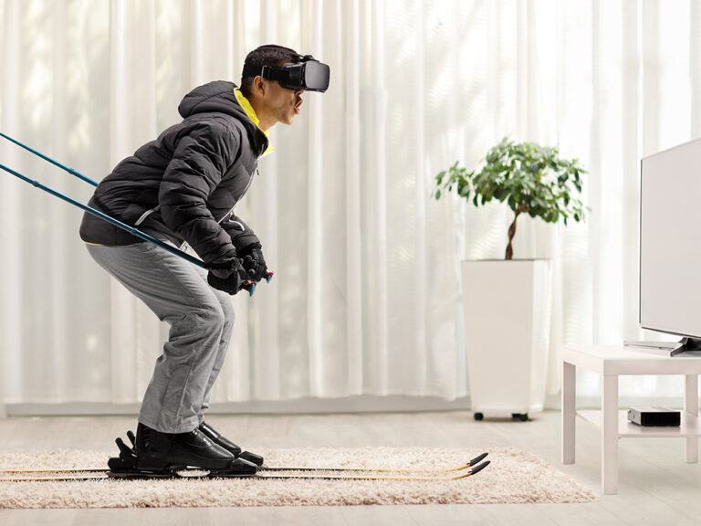 Man skiing with VR headset at home