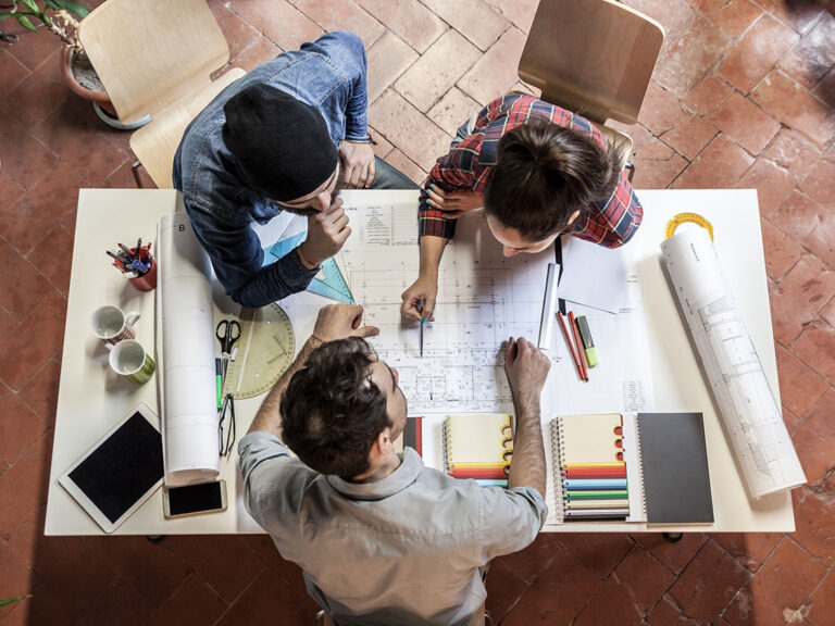 Teamwork. Three young architects working on a projec, ©loreanto / Adobe Stock
