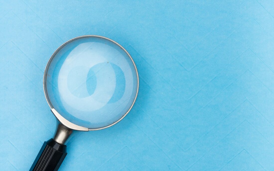 Image of a magnifying glass on a blue background
