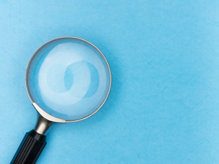 Image of a magnifying glass on a blue background