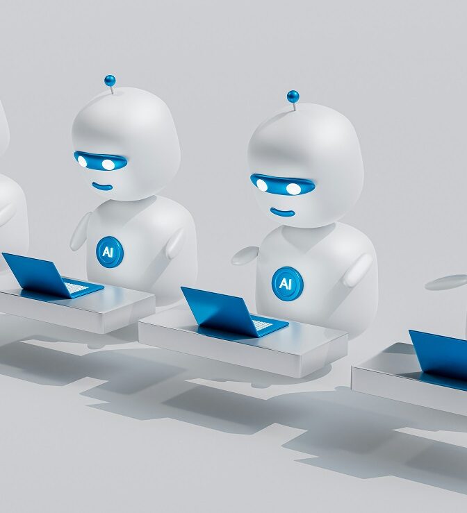 A line of 4 robots with AI written on their chest sit in front of computers