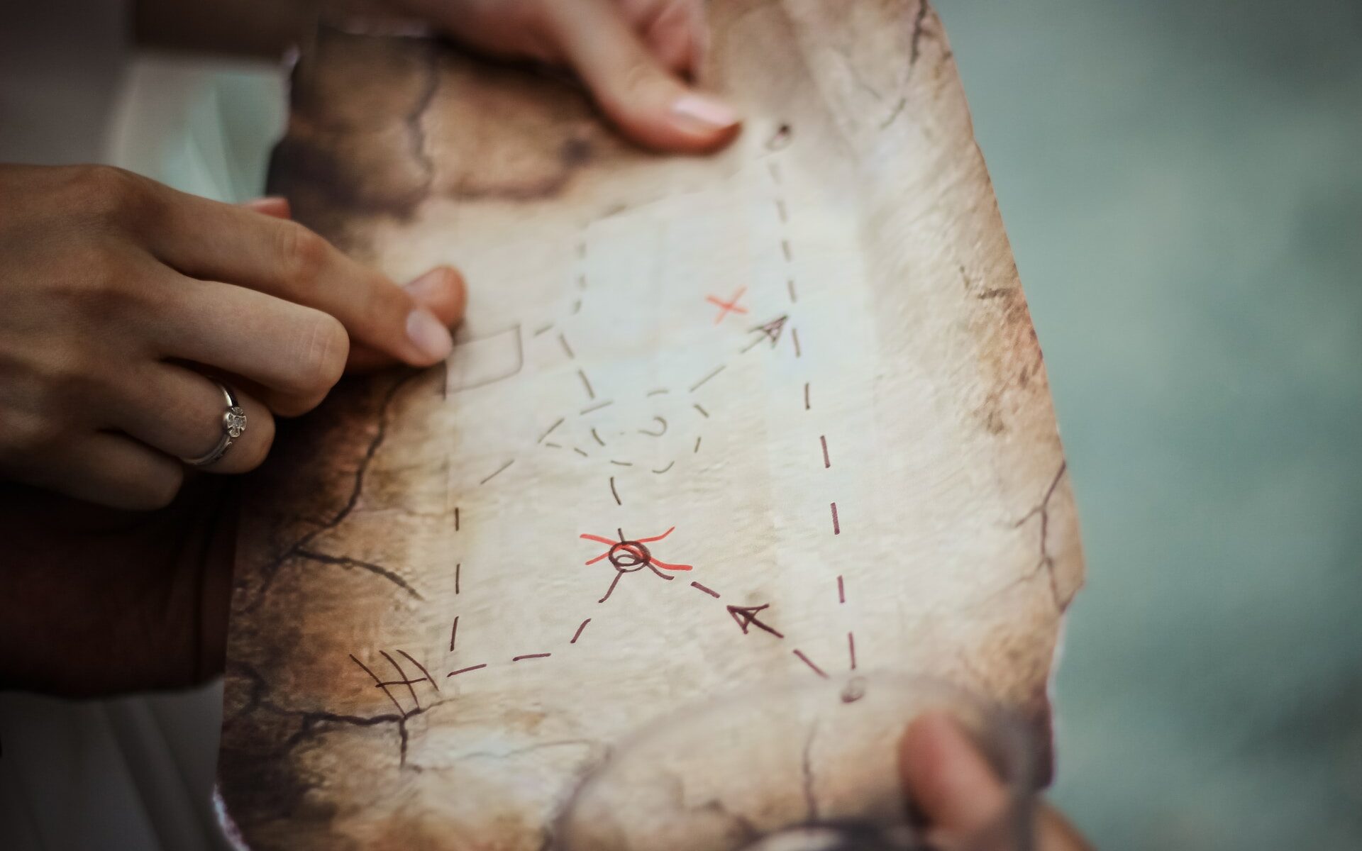 ©N / Unsplash Photo of people looking at a homemade treasure map