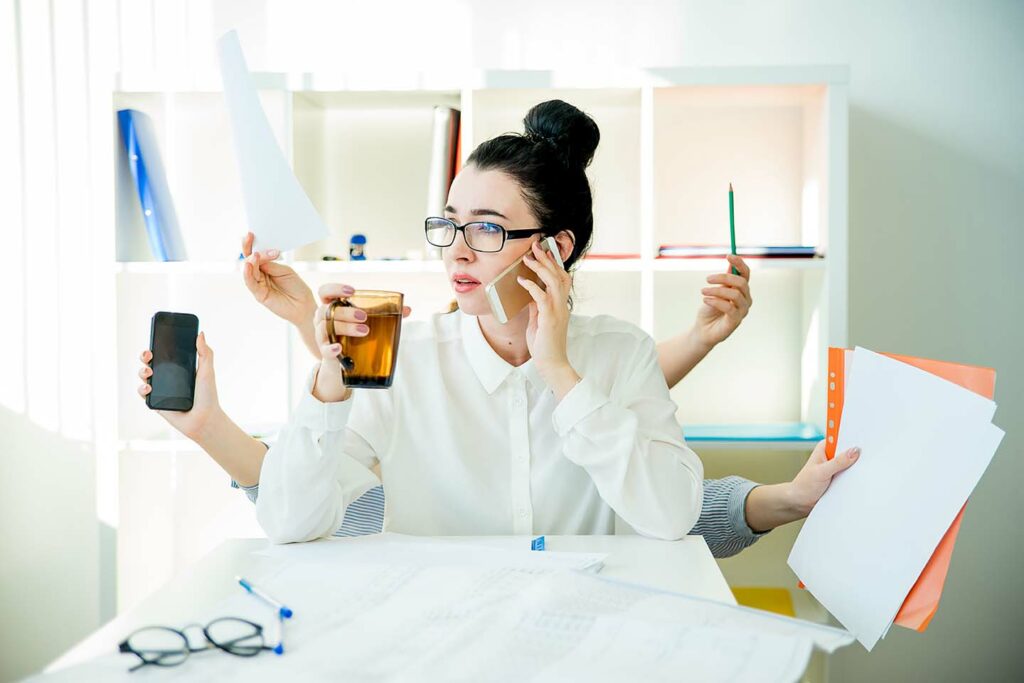 A successful businesswoman is multitasking in office